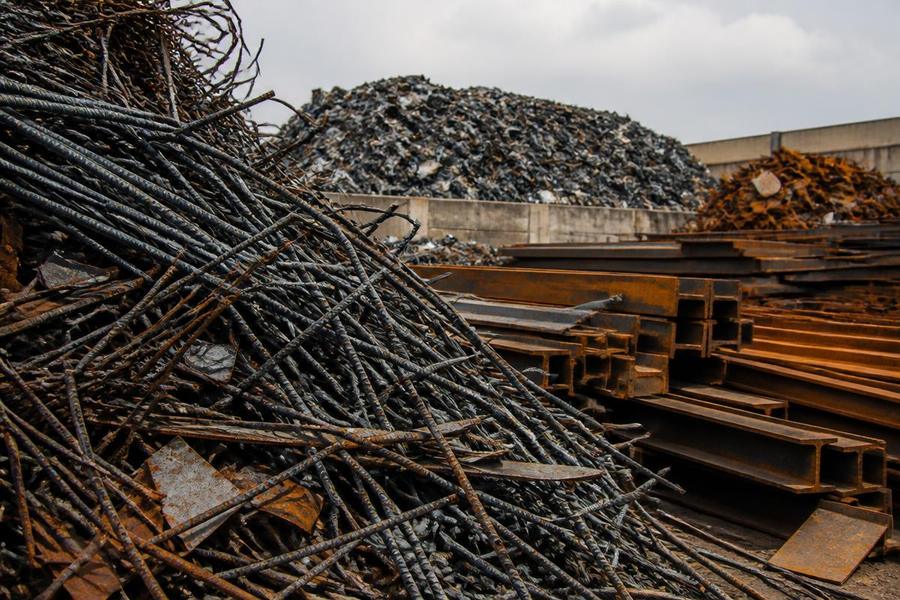 Ferrous scrap metal supply South Africa — steel scrap and secondary ferrous raw materials for steel mills Ferrous scrap metal including steel rebar and structural beams in a recycling yard